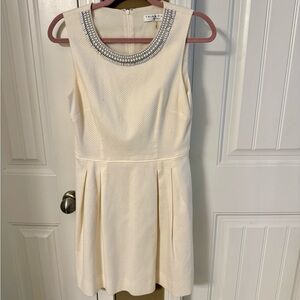 Elegant Cream Sleeveless Dress with Beaded Neckline